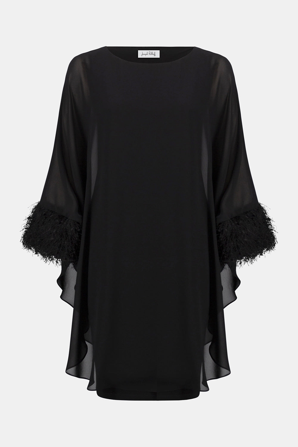 Joseph Ribkoff black silky knit and chiffon layered dress with fringe cuff detail, boat neckline and dolman sleeves, elegant women’s occasion dress at Hollie Rose.
